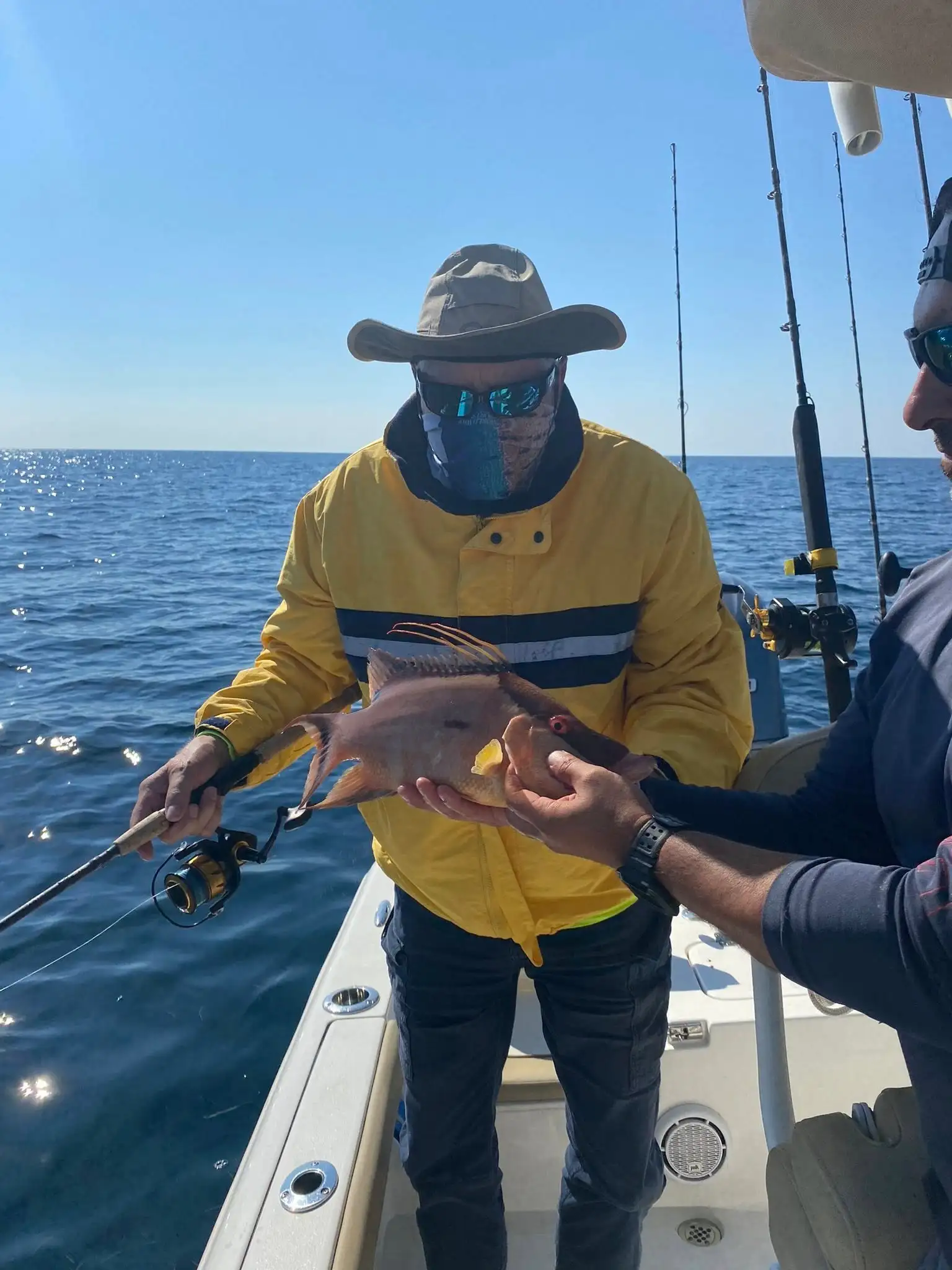 Happy customer holding a hogfish on the charter boat